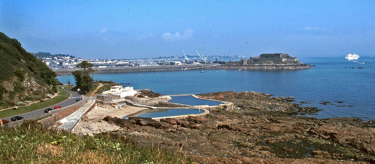St Peter Port coastline and Castle Cornet overlooking the blue sea in Guernsey